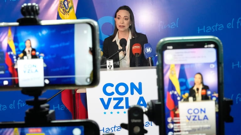 Opposition presidential hopeful Maria Corina Machado gives a press conference...