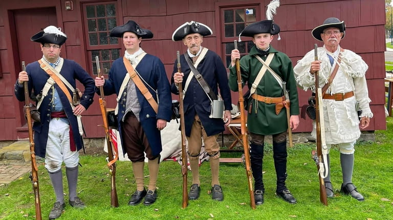 Revolutionary War re-enactors from the Huntington Militia pose during the...