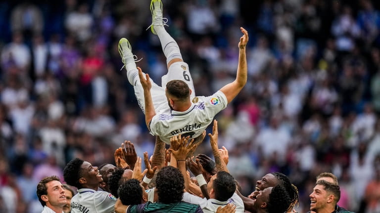 Real Madrid's Karim Benzema is thrown in the air by...