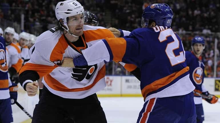 Kyle Okposo fights with Philadelphia Flyers defenseman Braydon Coburn in...