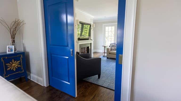 A bold blue makes the barn doors at Costello's home stand...