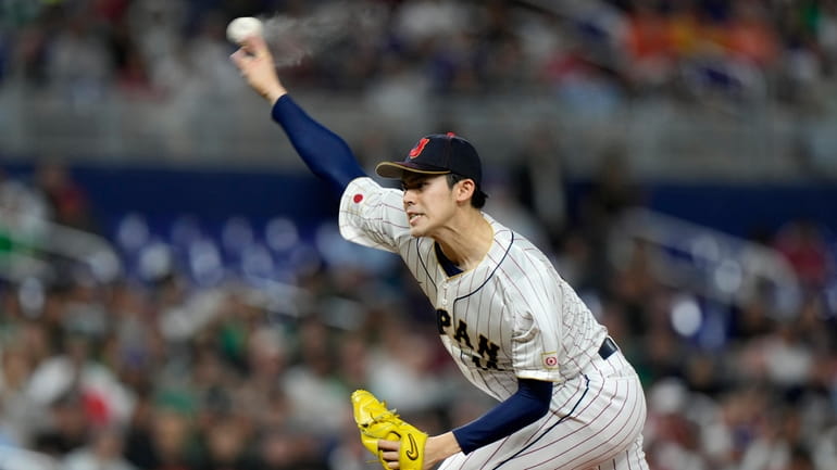 Japan's Roki Sasaki delivers a pitch during the first inning...