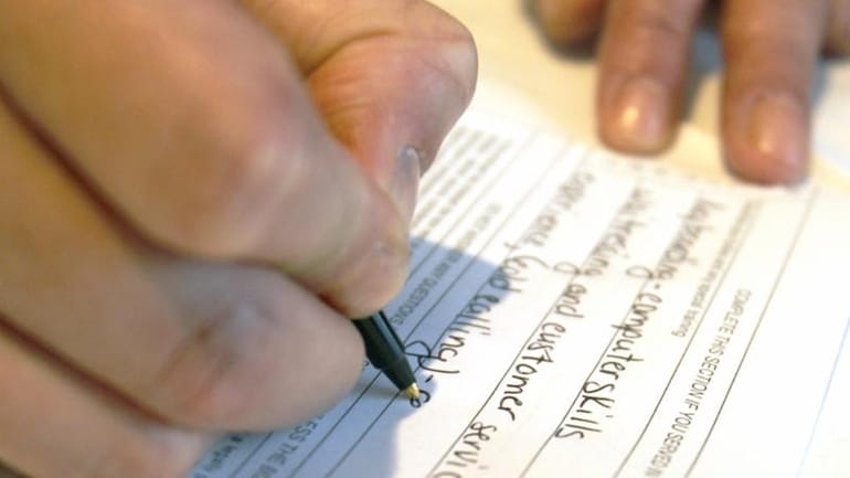 Sonya Mosey from Altoona, Pa. fills out an employment application...