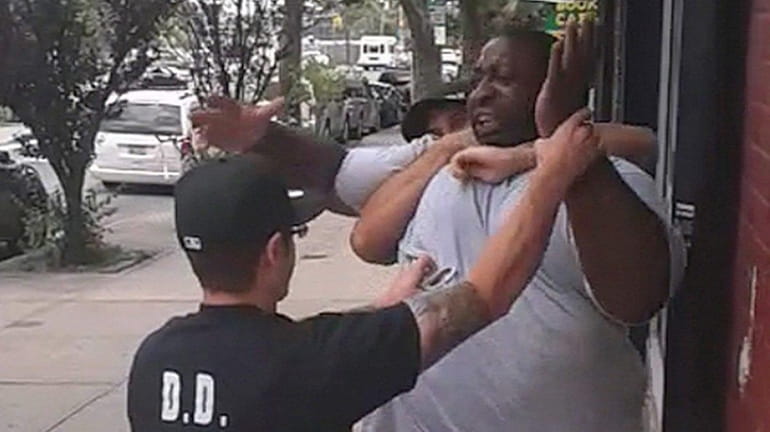 A cell phone frame grab shows the arrest of Eric...