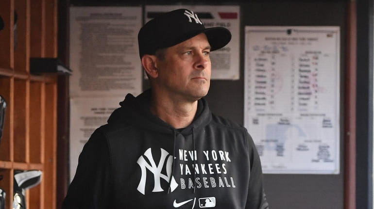 Yankees manager Aaron Boone looks on from the dugout against the...