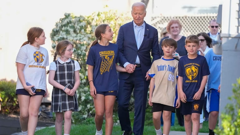 President Joe Biden walks out of his childhood home with...