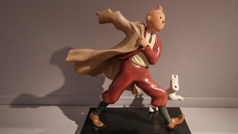 A 1988 polychrome resin sculpture of the comic character Tintin...
