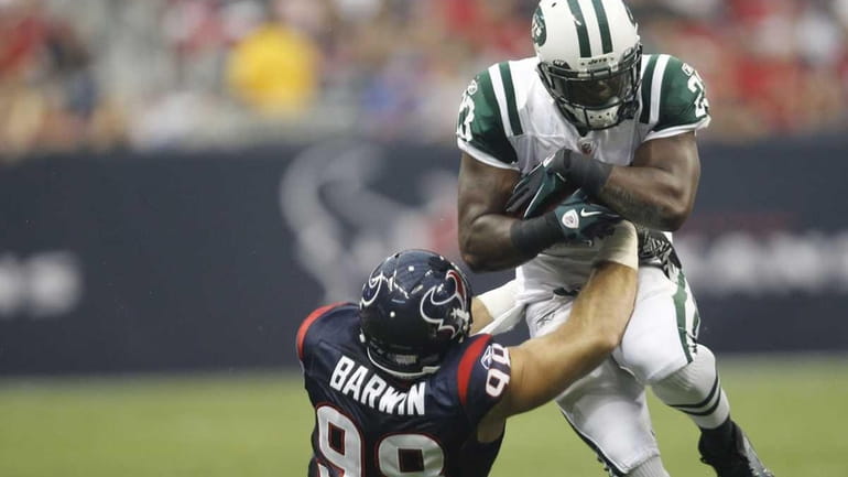 Houston Texans defensive end Connor Barwin gets a hold on...