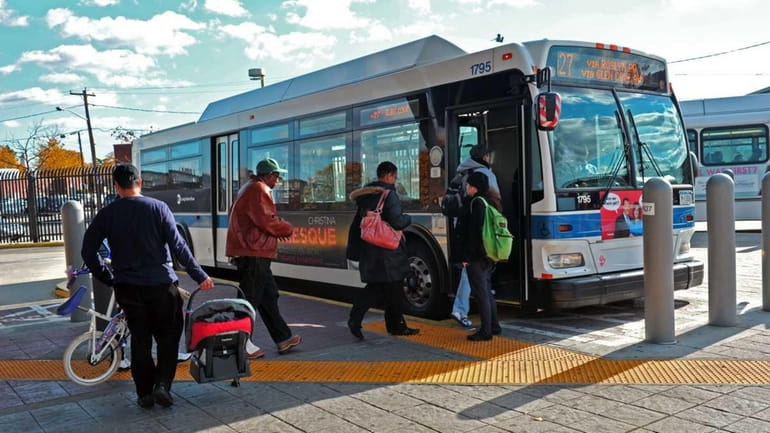 November 17, 2010--Passengers board the N27 Long Island Bus at...