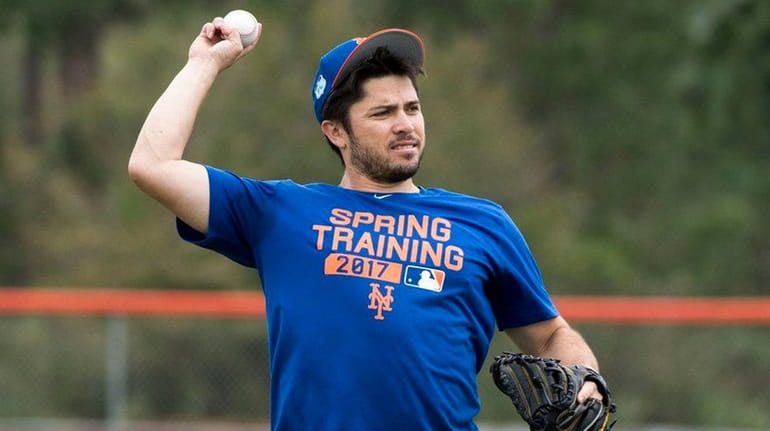 Mets catcher Travis d'Arnaud throws during a spring training workout...