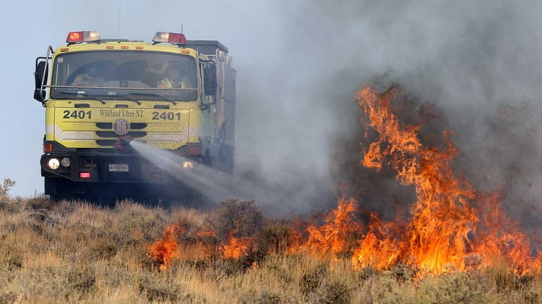 A U.S. Bureau of Land Management vehicle battles a wildfire...