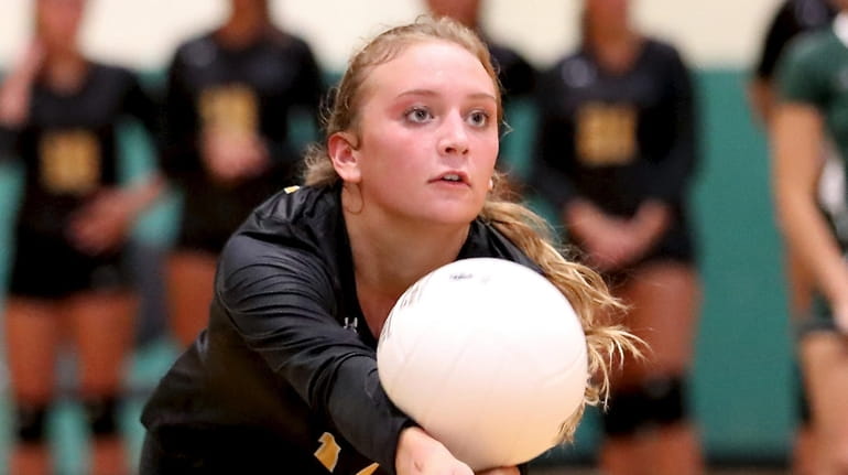 Commack girls volleyball captain Abbey Dummler gets the dig during a...