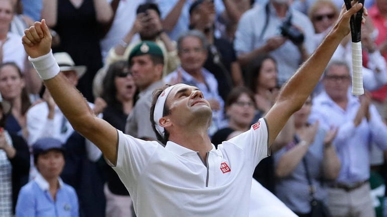 Roger Federer celebrates after beating Rafael Nadal in a men's...