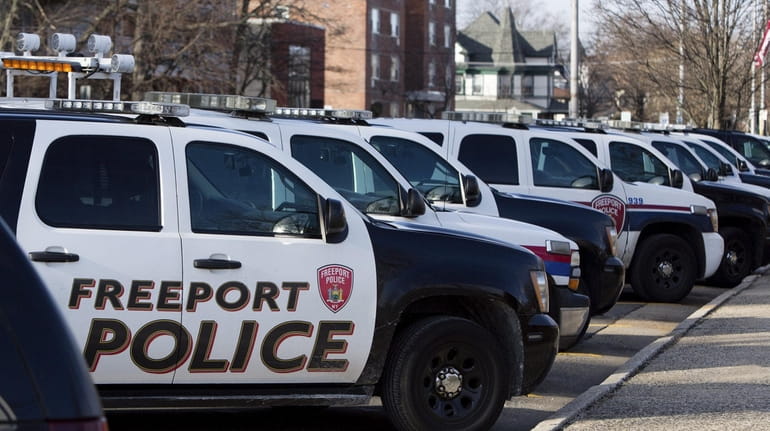 Patrol cars are parked outside Village of Freeport Police Headquarters...