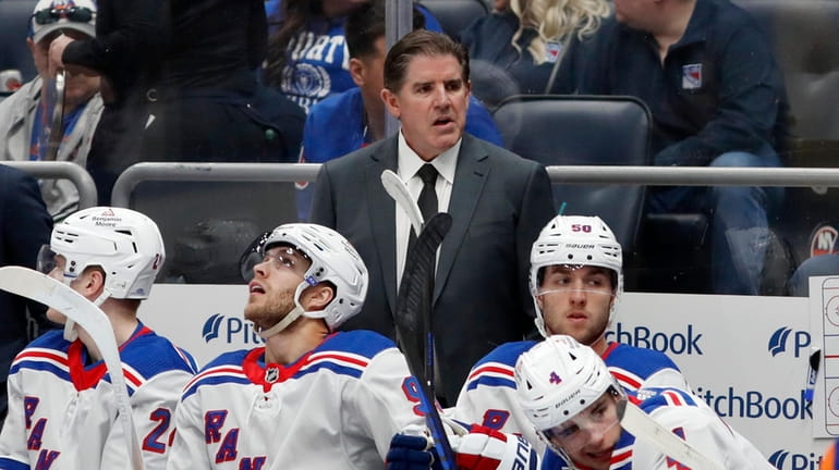 Head coach Peter Laviolette of the Rangers looks on against...