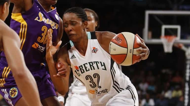 Liberty's Swin Cash drives against Los Angeles Sparks' Nneka Ogwumike...