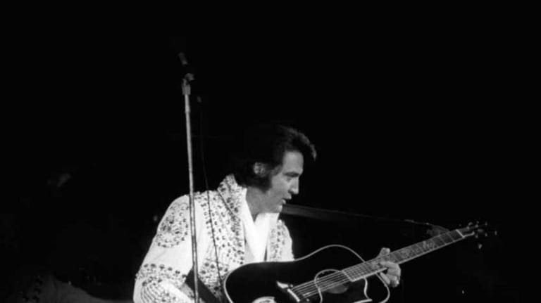 Elvis Presley on stage performing at the Nassau Coliseum in...