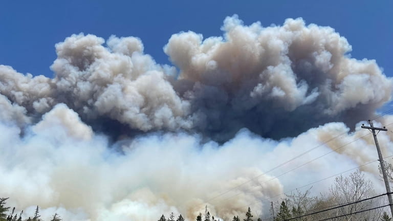 Smoke rises from a wildfire near Barrington Lake in Canada's...