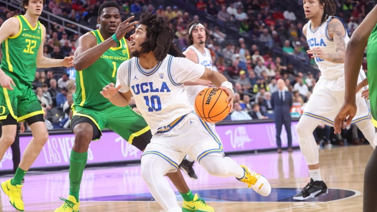 UCLA guard Tyger Campbell (10) drives to the basket against...
