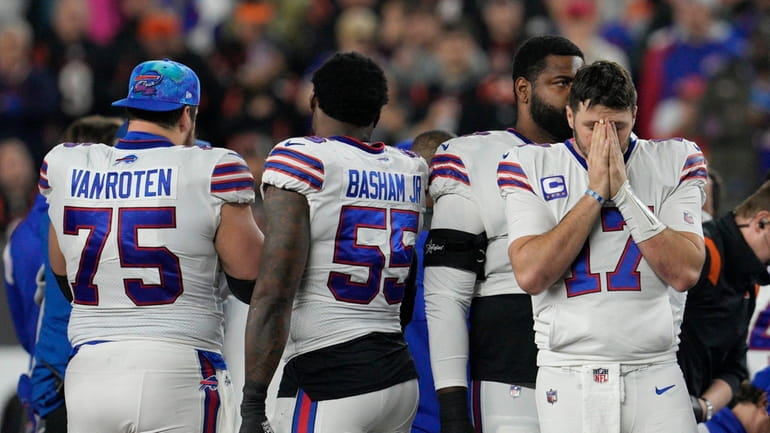 Buffalo Bills quarterback Josh Allen pauses as Damar Hamlin is...