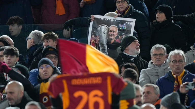 Roma's supporters show a photo with Roma's former coach Jose...