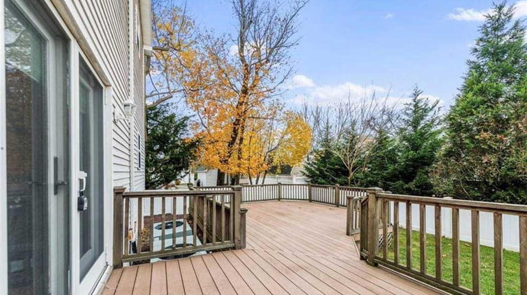 The house has a large backyard deck and fenced-in yard.