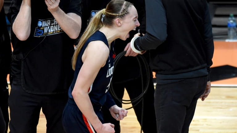 UConn guard Paige Bueckers celebrates after winning an Elite Eight...
