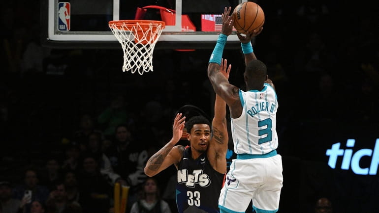 Charlotte Hornets guard Terry Rozier shoots over Brooklyn Nets center...