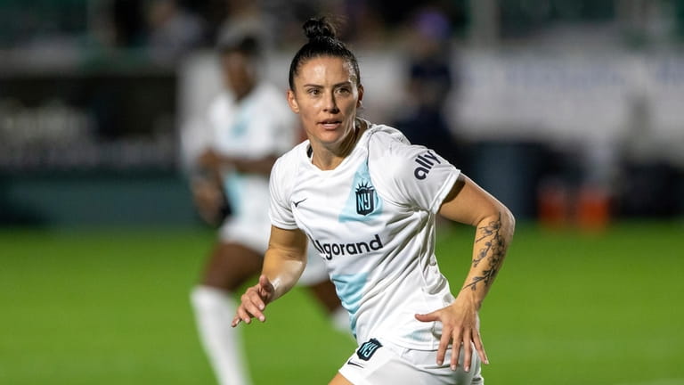 FILE - Gotham's Ali Krieger (11) chases down a ball...