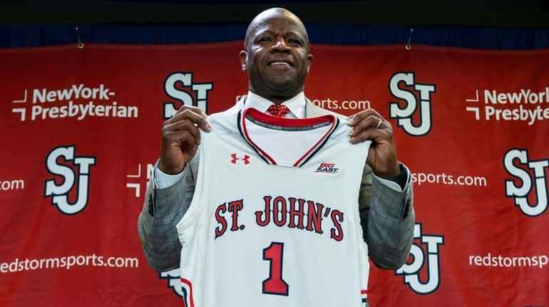 Mike Anderson holds a St. John's jersey after being introduced...