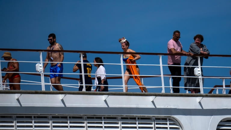 Passengers are photographed on the cruise ship MSC Armony, moored...