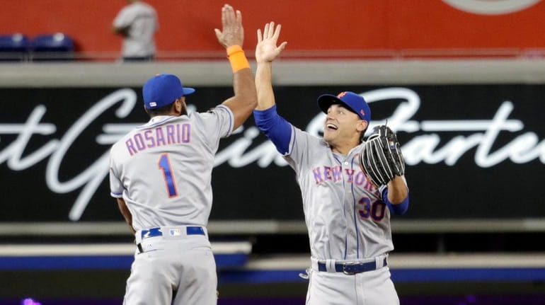 Mets shortstop Amed Rosario and outfielder Michael Conforto celebrate after...