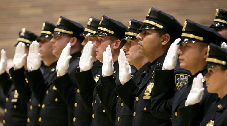 Members of the NYPD take the oath at a promotion...
