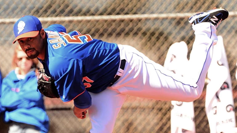 Johan Santana delivers a pitch from the mound during a...