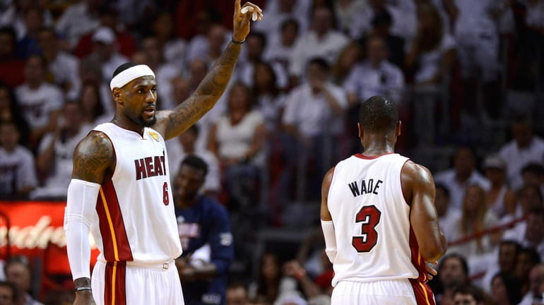 LeBron James #6 of the Miami Heat gestures on court...