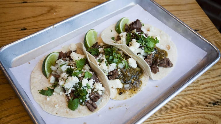 Carne asada street tacos, with salsa verde, raw onions and...
