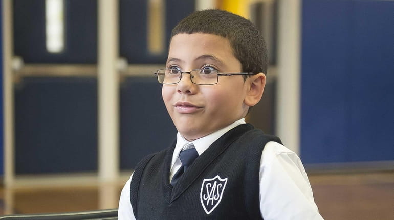 St. Ann School fourth-grader Noah Rodriguez reacts while talking to...