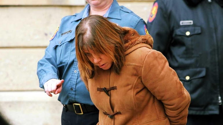 Anneliese Brucato, 48, is taken to her arraignment Monday in...