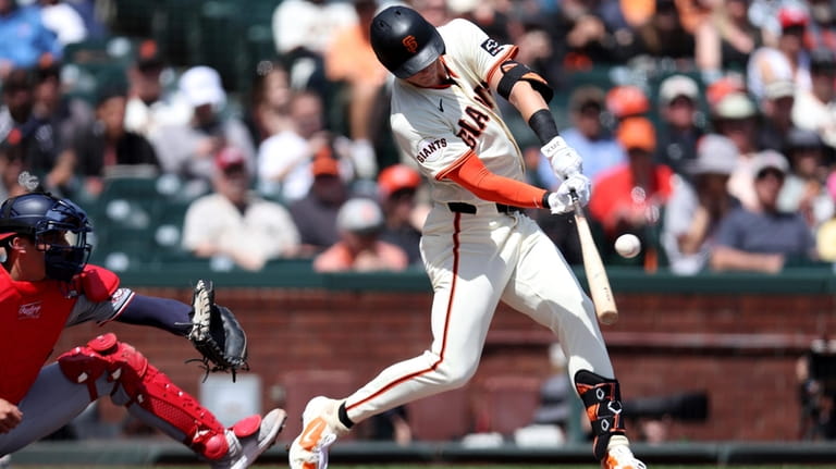 San Francisco Giants' Tyler Fitzgerald, right, hits an RBI single...