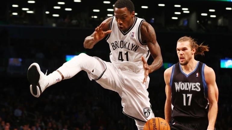 Tyshawn Taylor of the Brooklyn Nets loses the ball as...