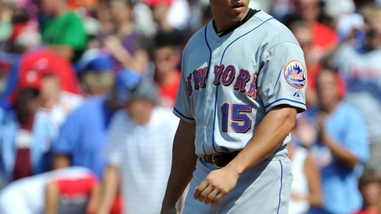 Mets center fielder Carlos Beltran reacts after striking out to...