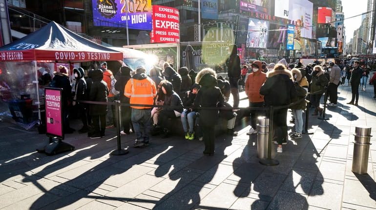 Hundreds gather at a COVID testing station in Times Square on...