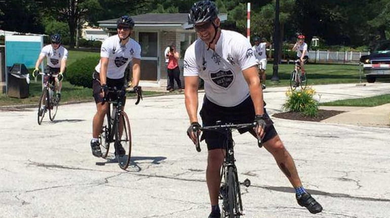The priests and seminarians, dubbed "Biking 4 Vocations," during their...