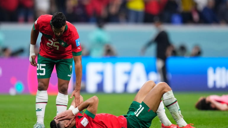 Morocco's Yahia Attiyat Allah consoles a teammate at the end...