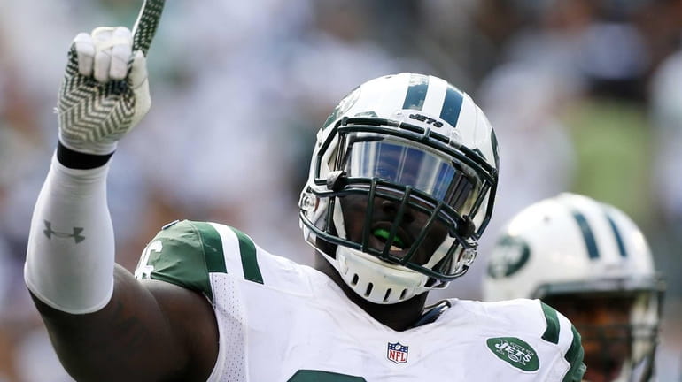 Muhammad Wilkerson #96 of the Jets reacts after tipping a...