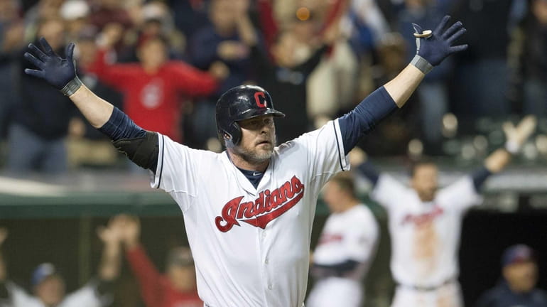 Jason Giambi of the Cleveland Indians celebrates after hitting a...