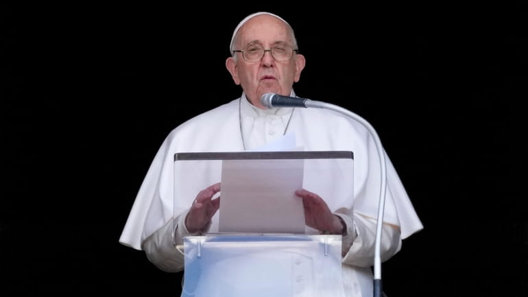 Pope Francis delivers his speech as he recites the Regina...