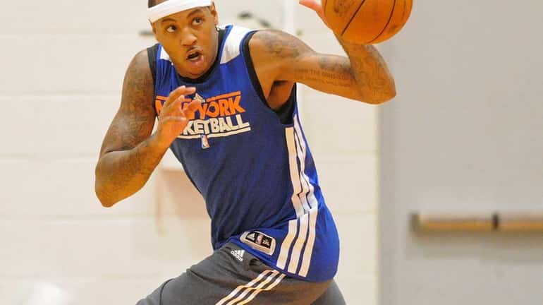 Carmelo Anthony passes while racing downcourt during team practice held...