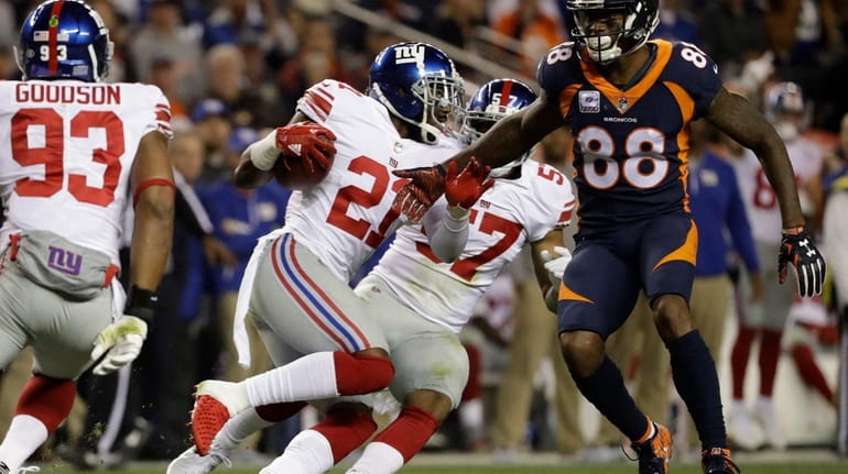Giants strong safety Landon Collins, center, runs after intercepting a...