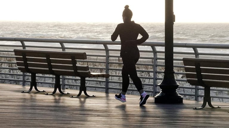 An early morning jogger on the boardwalk in Long Beach...